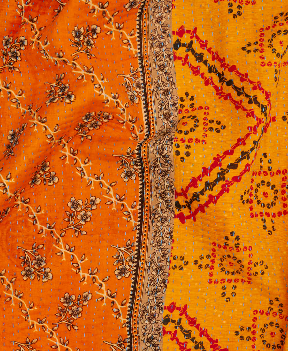 saffron geometric kantha quilt throw with a tag featuring the hand-stitched signature of the maker