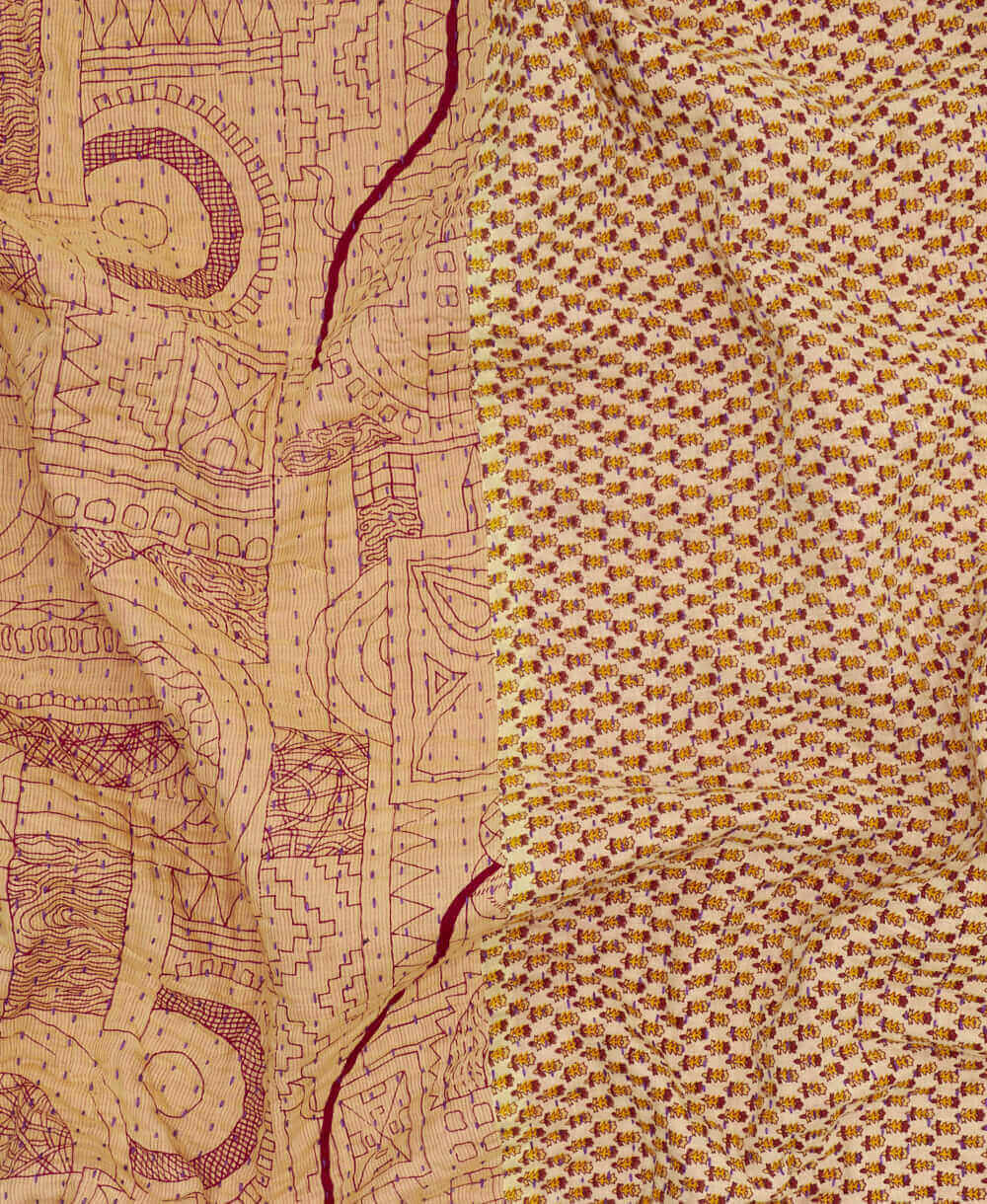  almond geometric kantha quilt throw with a tag featuring the hand-stitched signature of the maker