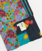 cerulean, black & red kantha quilt throw with a tag featuring the hand-stitched signature of the maker