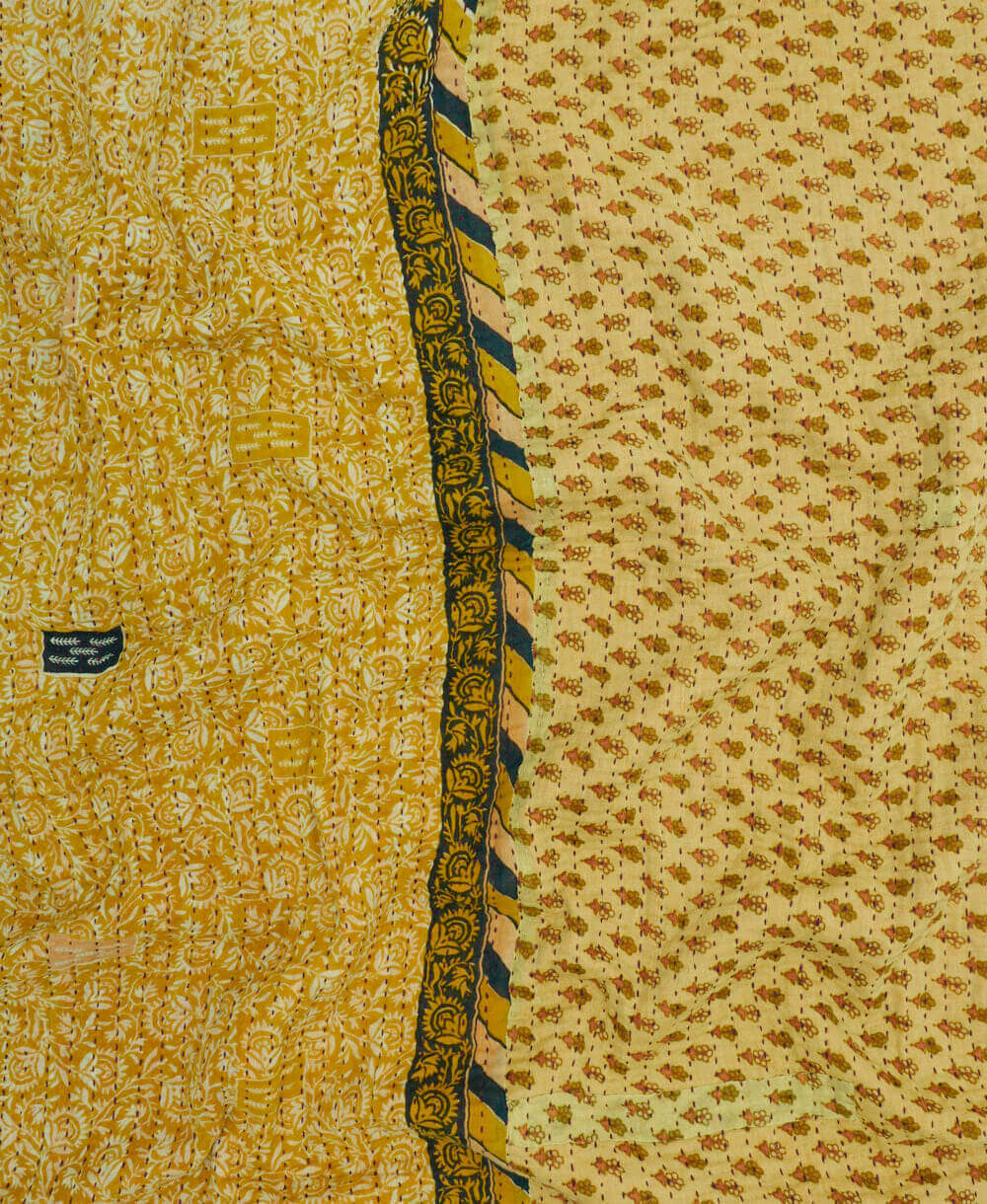 Kantha quilt throw featuring yellow-green floral print & black traditional kantha hand stitching