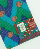 teal & blue chevron kantha quilt throw with a tag featuring the hand-stitched signature of the maker