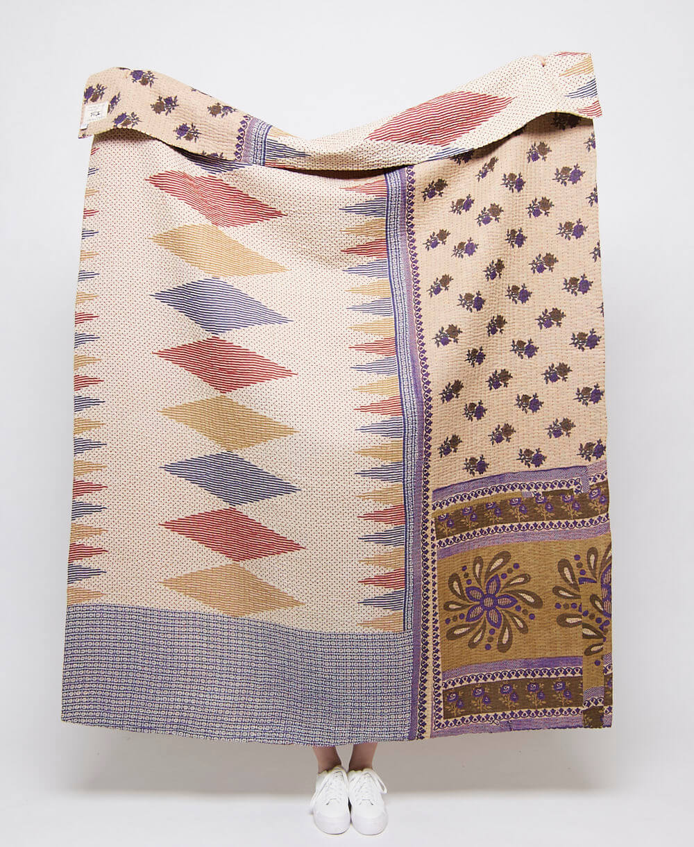 Artisan made sandy beige kantha quilt throw with eggplant floral and red, tan and royal blue diamond print  