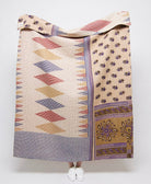 Artisan made sandy beige kantha quilt throw with eggplant floral and red, tan and royal blue diamond print  