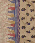 sandy tan kantha quilt throw with a tag featuring the hand-stitched signature of the maker