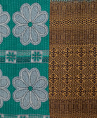 teal daisy kantha quilt throw with a tag featuring the hand-stitched signature of the maker