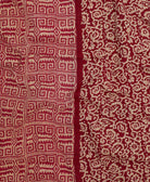 Kantha quilt throw featuring white traditional kantha hand stitching in cranberry red geometric print