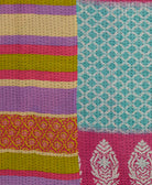 bubblegum pink, purple & lime stripe kantha quilt throw with a tag featuring the hand-stitched signature of the maker