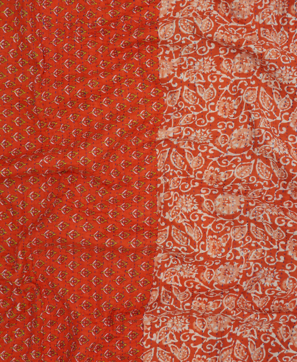 Kantha quilt throw featuring white traditional kantha hand stitching in a persimmon orange & white floral