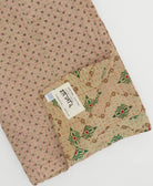 yellow-beige & emerald diamond kantha quilt throw with a tag featuring the hand-stitched signature of the maker