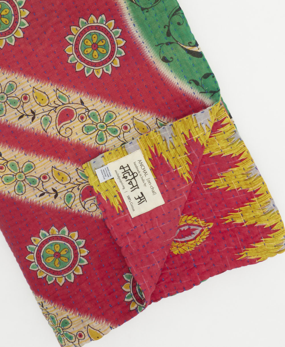 hot pink & yellow chevron kantha quilt throw with a tag featuring the hand-stitched signature of the maker