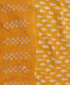 Kantha quilt throw featuring yellow-orange floral traditional kantha hand stitching