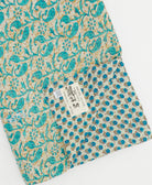 kantha quilt throw with a tag featuring the hand-stitched signature of the maker