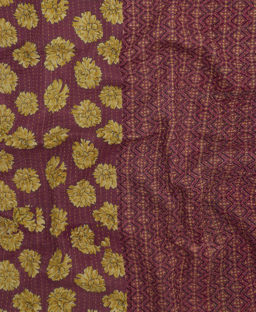 kantha quilt throw with a tag featuring the hand-stitched signature of the maker
