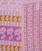 kantha quilt throw with a tag featuring the hand-stitched signature of the maker