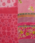 kantha quilt throw with a tag featuring the hand-stitched signature of the maker