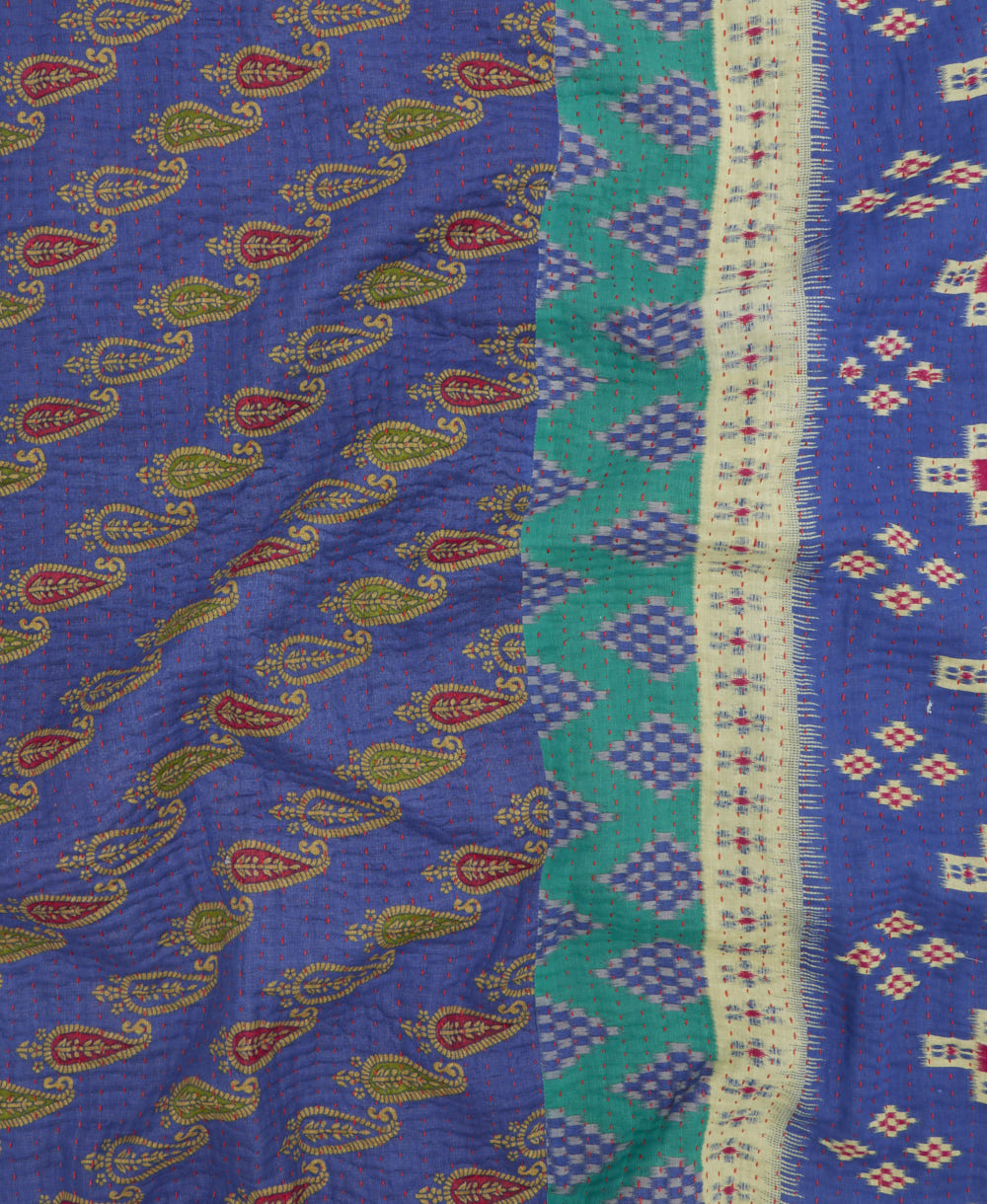 kantha quilt throw with a tag featuring the hand-stitched signature of the maker