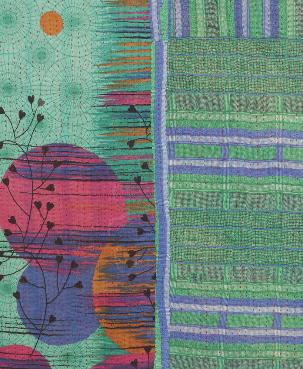 kantha quilt throw with a tag featuring the hand-stitched signature of the maker