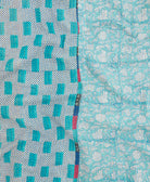 kantha quilt throw with a tag featuring the hand-stitched signature of the maker