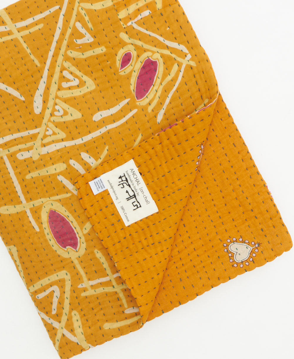 Kantha quilt throw featuring traditional kantha hand stitching