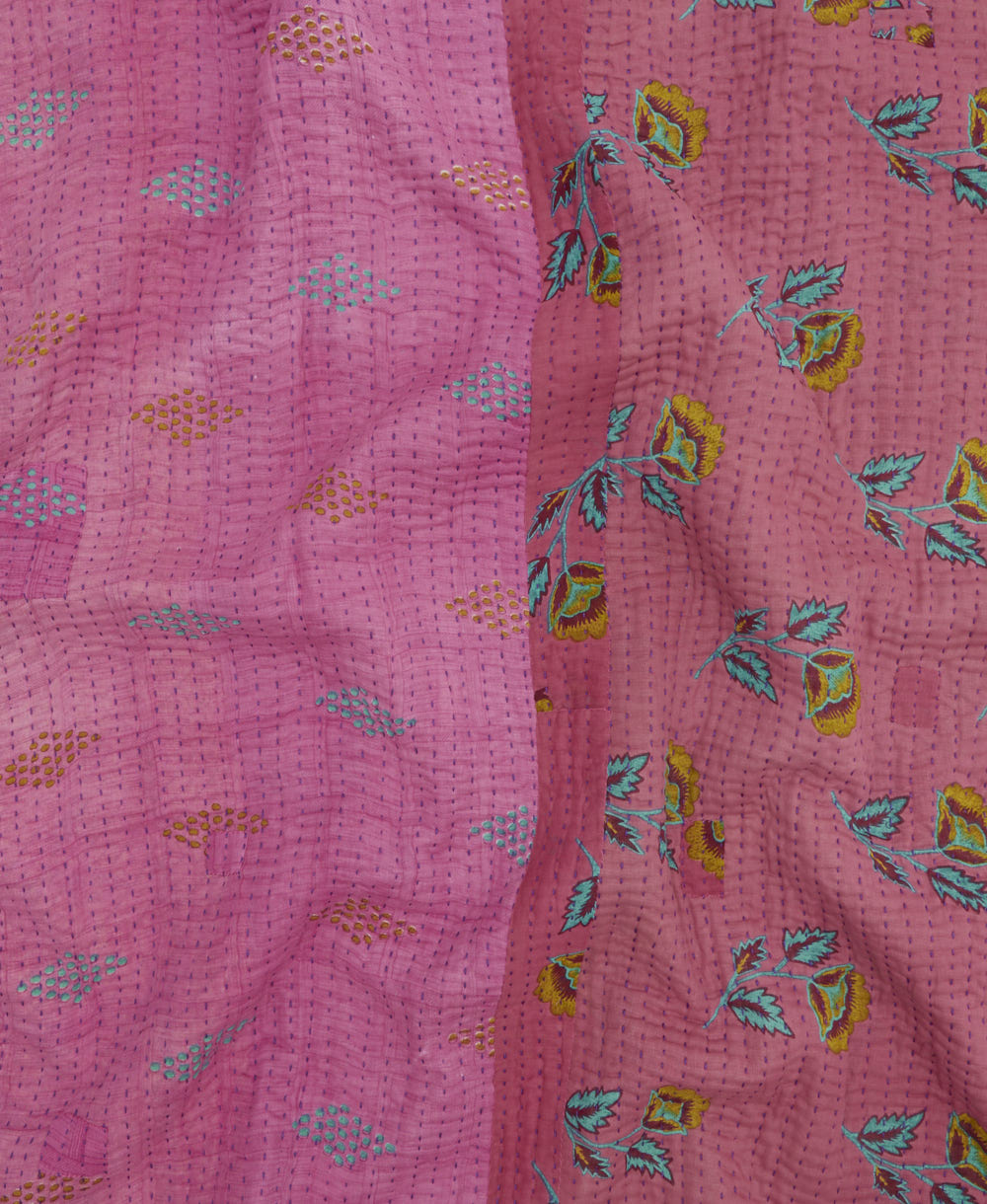 kantha quilt throw with a tag featuring the hand-stitched signature of the maker