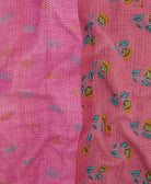 kantha quilt throw with a tag featuring the hand-stitched signature of the maker