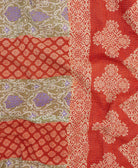 kantha quilt throw with a tag featuring the hand-stitched signature of the maker