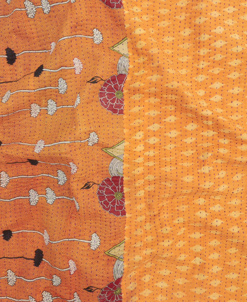 kantha quilt throw with a tag featuring the hand-stitched signature of the maker