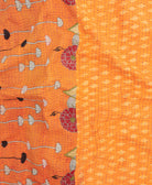 kantha quilt throw with a tag featuring the hand-stitched signature of the maker