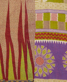 kantha quilt throw with a tag featuring the hand-stitched signature of the maker