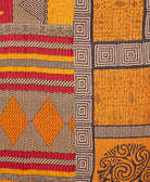 kantha quilt throw with a tag featuring the hand-stitched signature of the maker