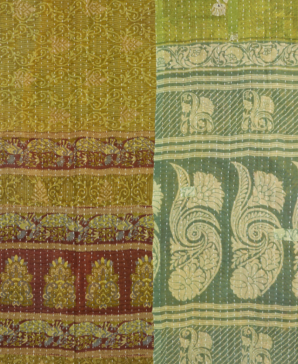 kantha quilt throw with a tag featuring the hand-stitched signature of the maker