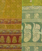 kantha quilt throw with a tag featuring the hand-stitched signature of the maker