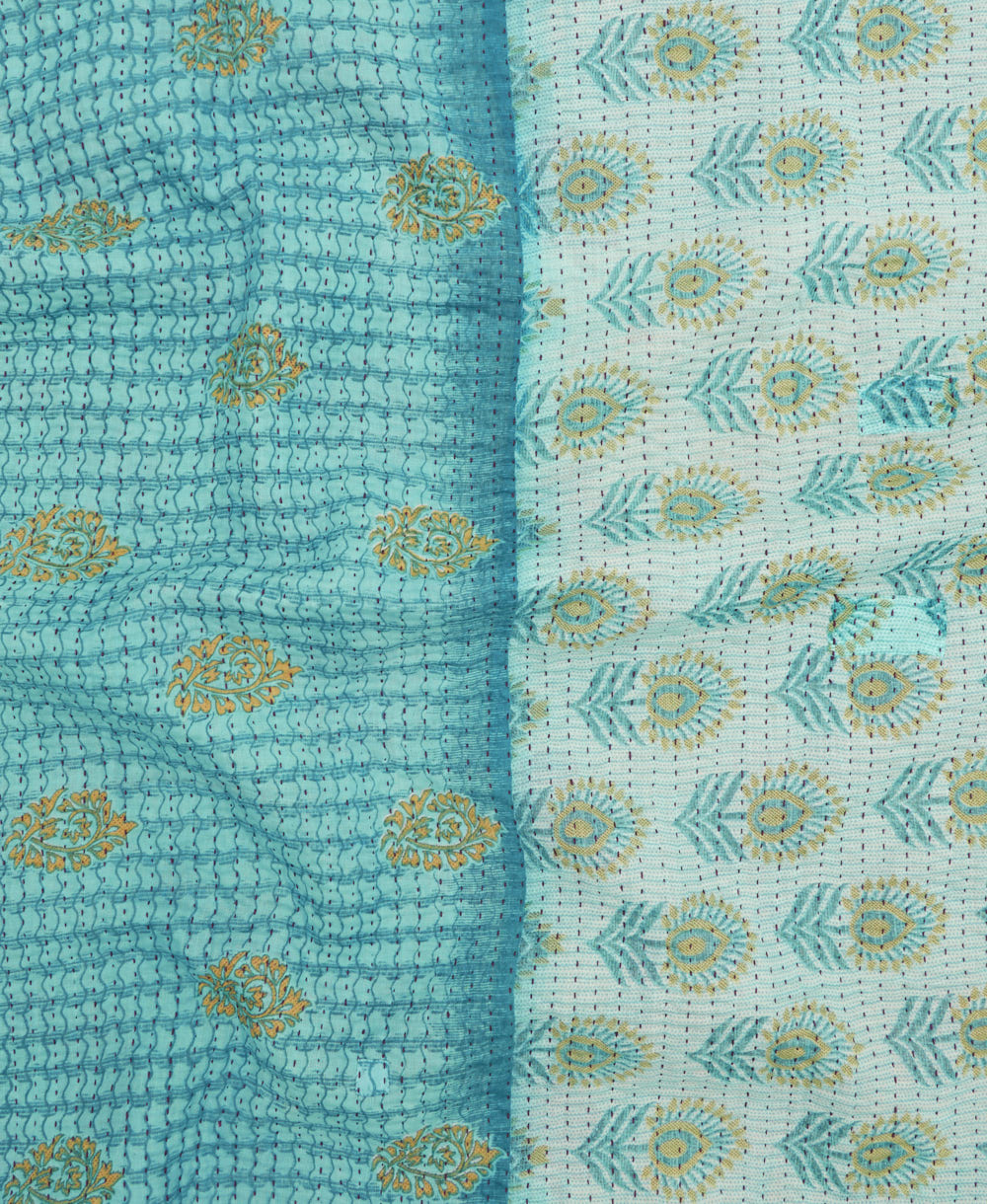 kantha quilt throw with a tag featuring the hand-stitched signature of the maker