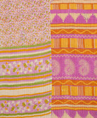 kantha quilt throw with a tag featuring the hand-stitched signature of the maker