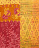 kantha quilt throw with a tag featuring the hand-stitched signature of the maker