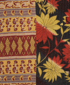 kantha quilt throw with a tag featuring the hand-stitched signature of the maker