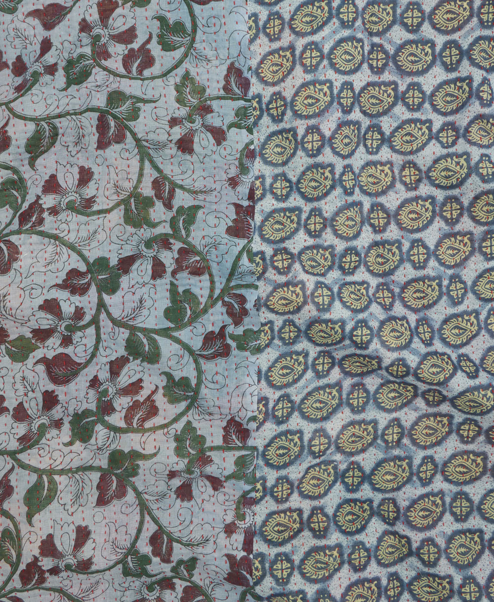 kantha quilt throw with a tag featuring the hand-stitched signature of the maker