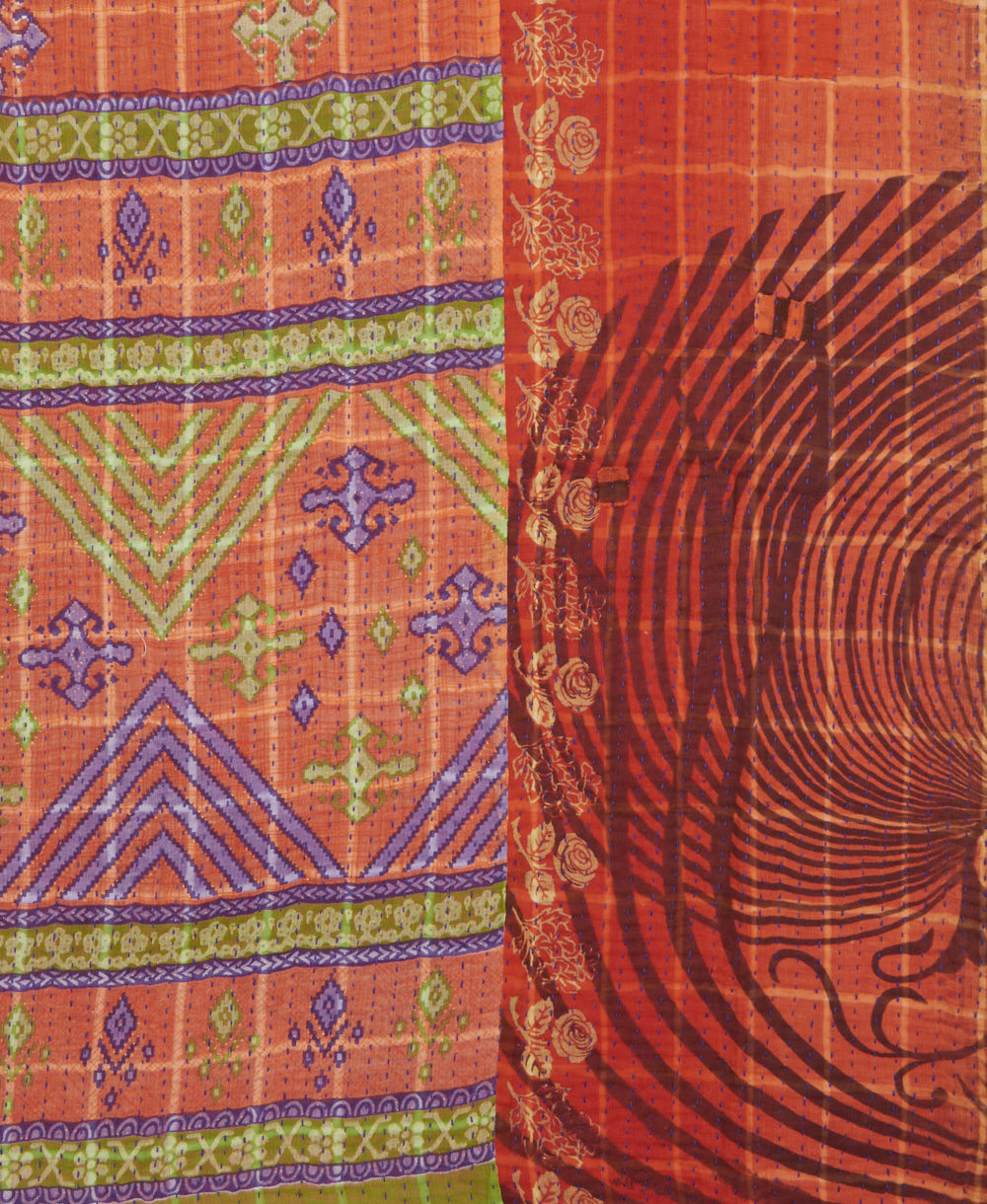 kantha quilt throw with a tag featuring the hand-stitched signature of the maker