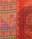 kantha quilt throw with a tag featuring the hand-stitched signature of the maker