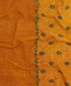 kantha quilt throw with a tag featuring the hand-stitched signature of the maker