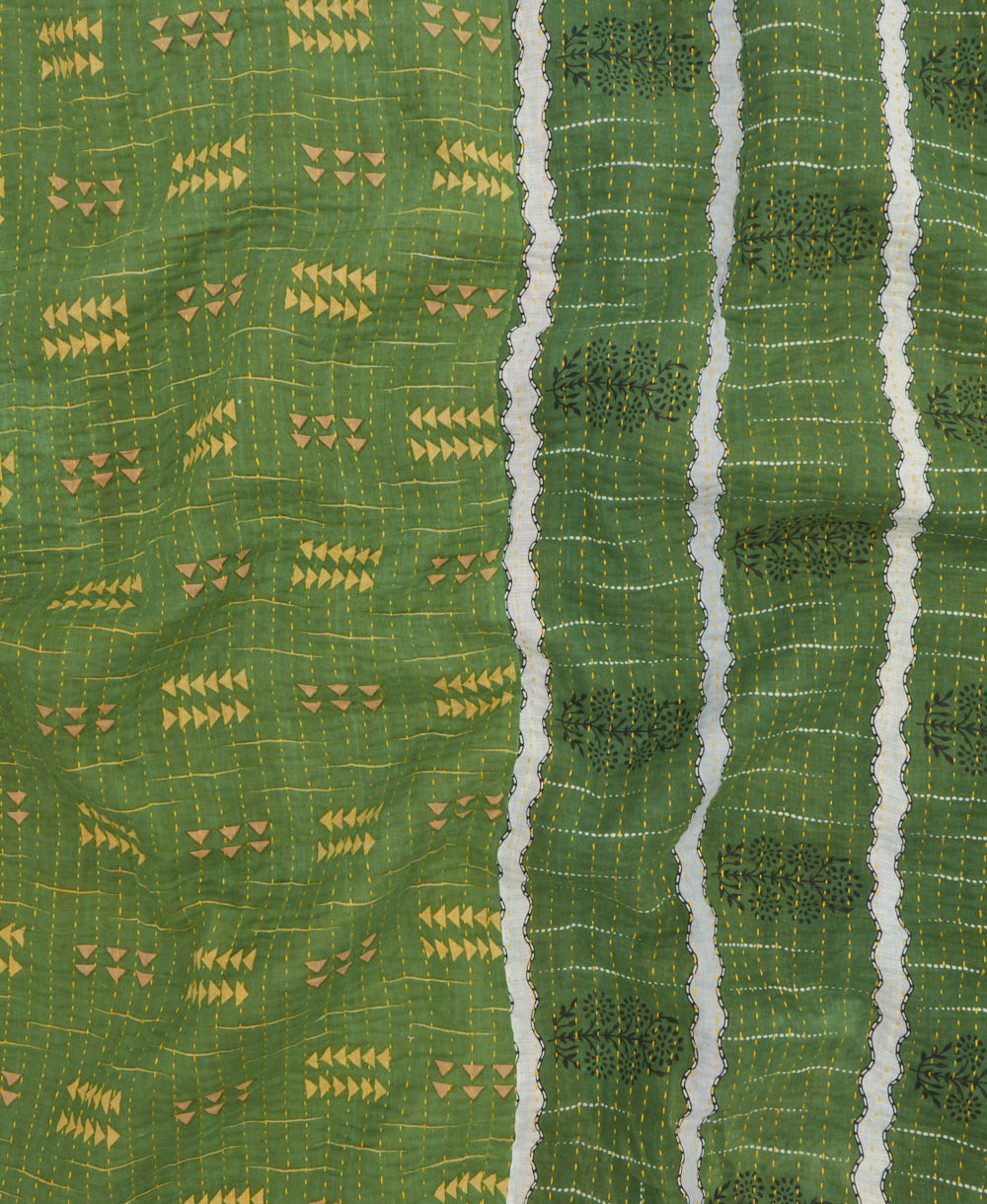 kantha quilt throw with a tag featuring the hand-stitched signature of the maker