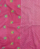 kantha quilt throw with a tag featuring the hand-stitched signature of the maker