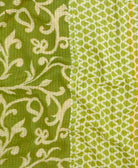 kantha quilt throw with a tag featuring the hand-stitched signature of the maker