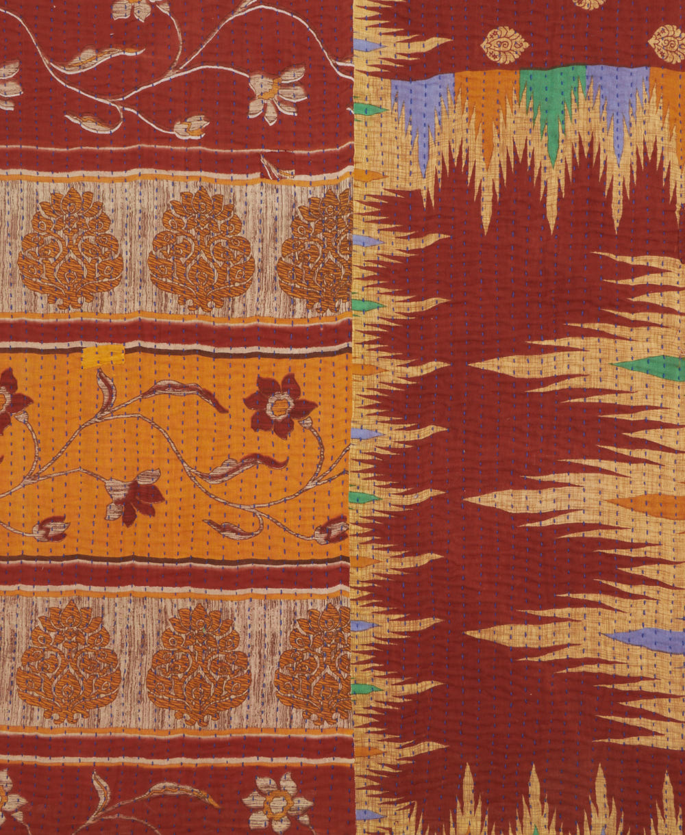 kantha quilt throw with a tag featuring the hand-stitched signature of the maker