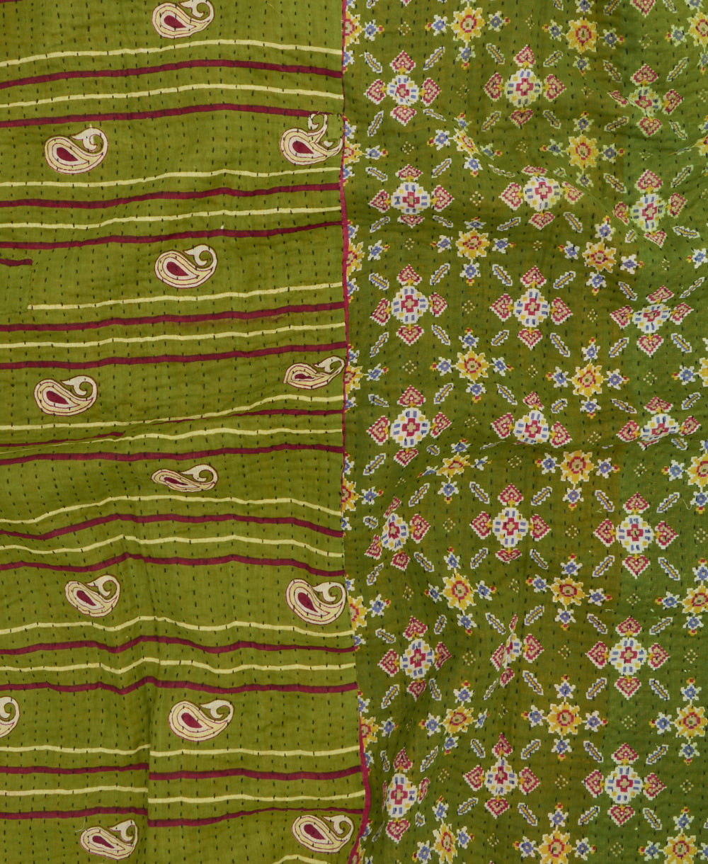 kantha quilt throw with a tag featuring the hand-stitched signature of the maker