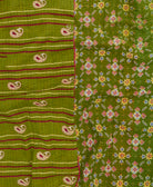 kantha quilt throw with a tag featuring the hand-stitched signature of the maker