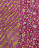 kantha quilt throw with a tag featuring the hand-stitched signature of the maker