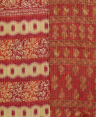 kantha quilt throw with a tag featuring the hand-stitched signature of the maker