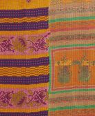 kantha quilt throw with a tag featuring the hand-stitched signature of the maker