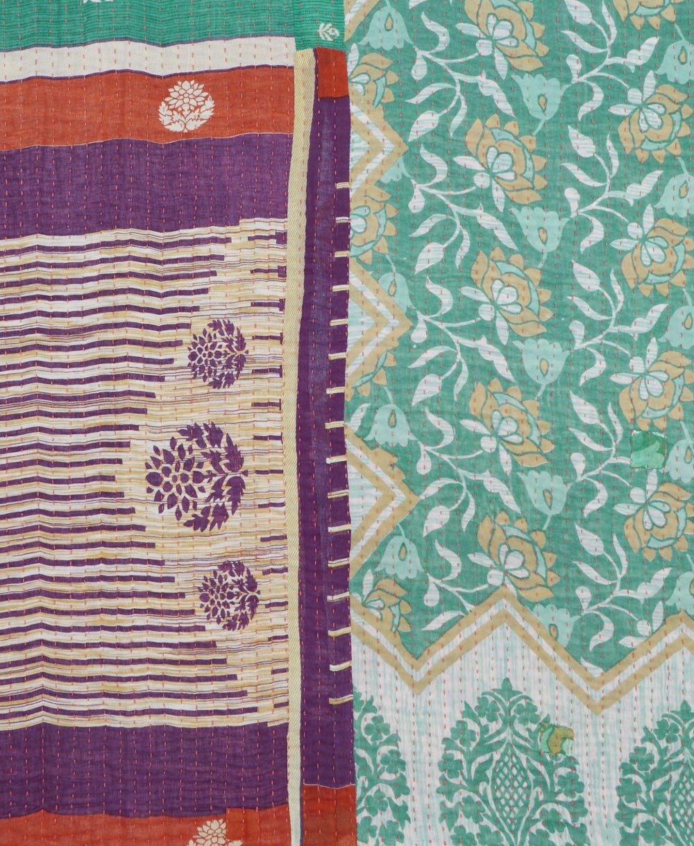 kantha quilt throw with a tag featuring the hand-stitched signature of the maker